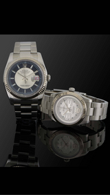 Two rolex watches with reflective surfaces on a black background