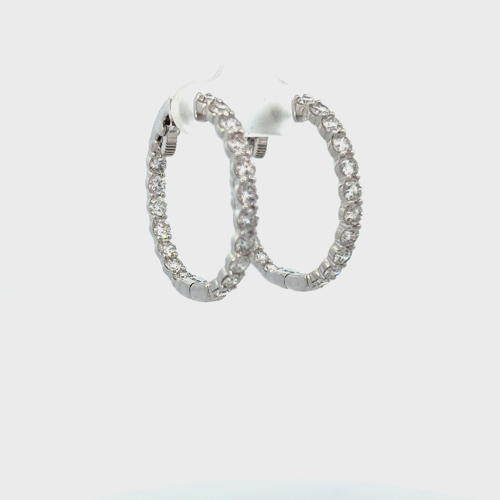 14KT WHITE GOLD AND ROUND CUT DIAMOND IN AND OUT HOOP EARRING.