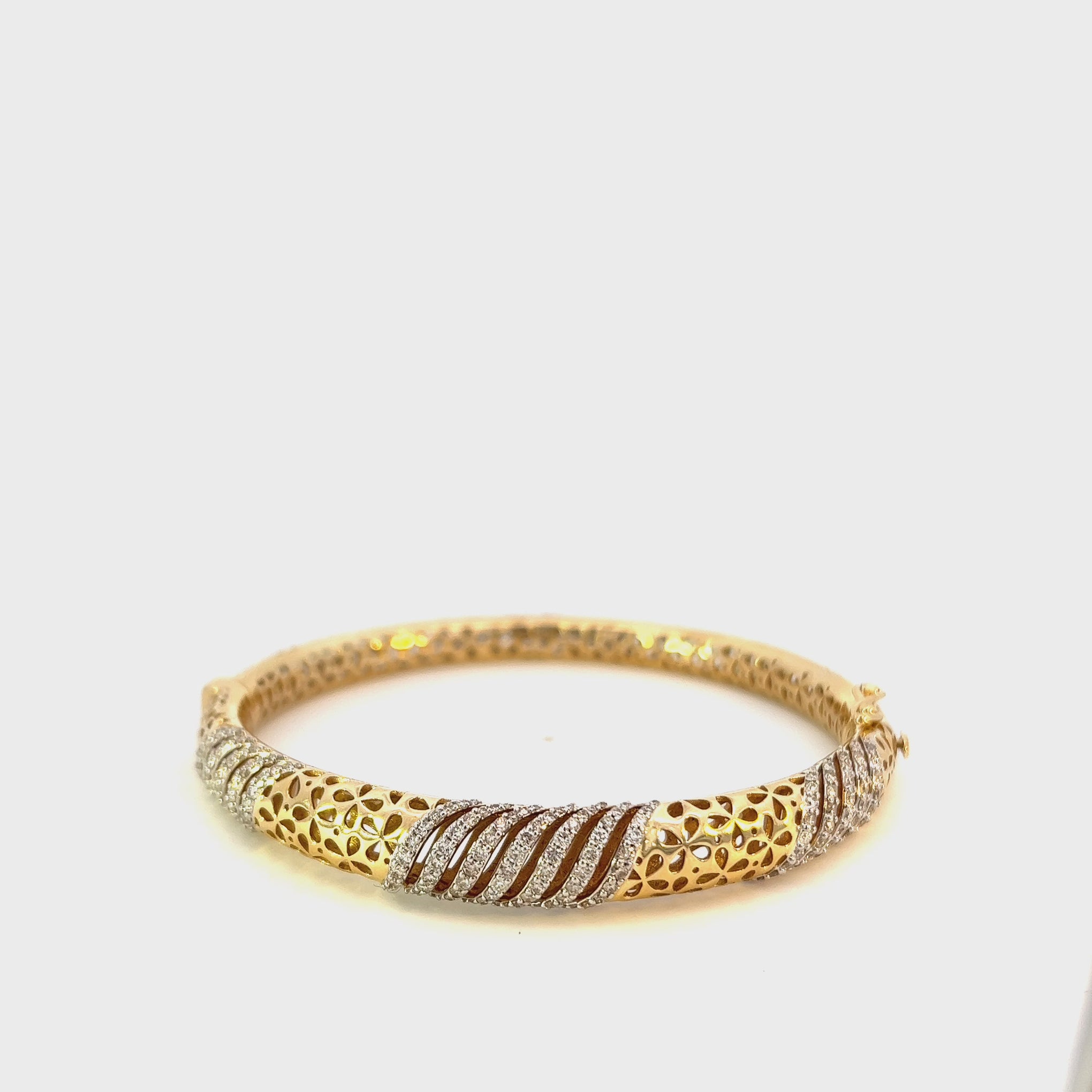 14KT Yellow Gold With Round Cut Diamonds Swirl Design With Eyelet Detailing Bangle